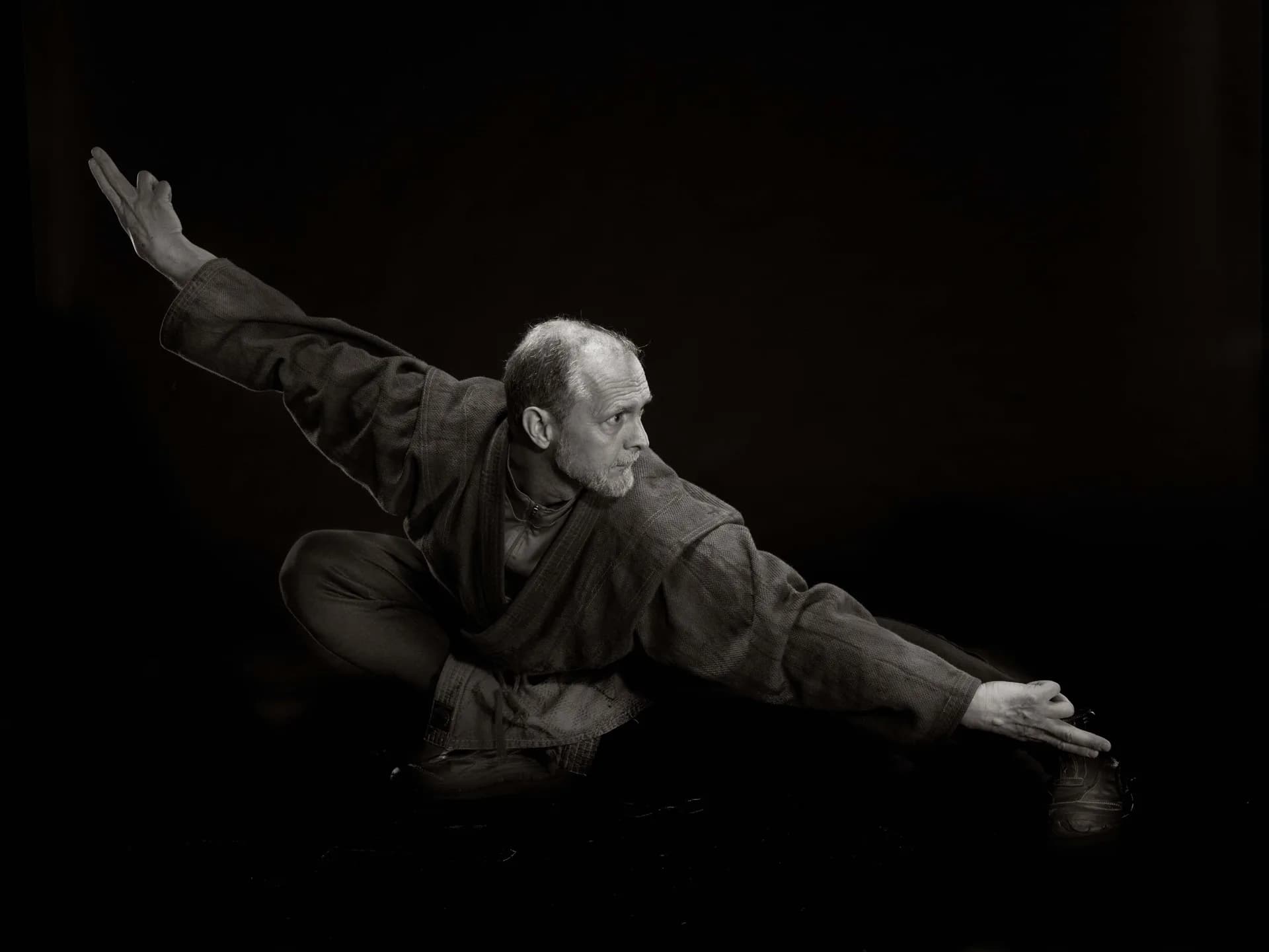Allen Pittman moving with open arms against a dark background