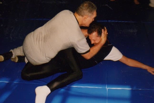 Tim Geoghegan and Allen Pittman training together on a wrestling mat