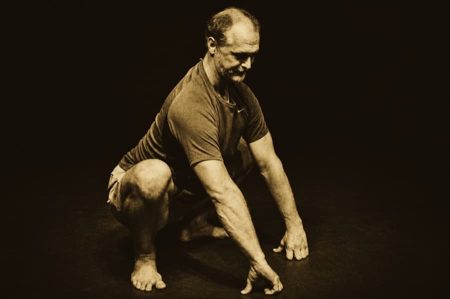 Allen Pittman gathering his weight into a low squat
